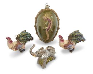 1314 Four Jay Strongwater holiday ornaments Late 20th century Each with maker's applied metal tag Comprising an egg with lizard in relief, two roosters, and an elephant, each enameled and with inset cut glass jewels and with original retailer's box with formed interior 4 pieces Egg height 6 in., width 3 1/2 in., depth 3 1/8 in.; largest box height 6 5/8 in., width 7 1/4 in., depth 7 1/4 in. Estimate: $400 - $600