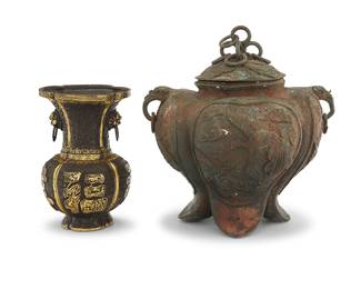 1291 Five Chinese bronze table items 19th/20th century Censer and vase each with debossed mark to underside Comprising a pair of duck forms with wing lids, a black and gold-toned painted vase with figural ring handles, a lidded censer with pierced lid and guardian lion-form handles and finial, and a lidded pot decorated with phoenixes in relief 5 pieces Pot height 13 1/4 in., width 12 in., depth 10 3/4 in.; height of each duck 10 3/8 in.; censer height 8 in. Estimate: $250 - $350