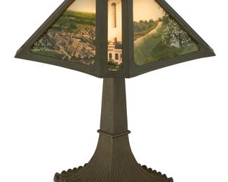 1150 An American photographic interior decorated glass table lamp Circa 1920s Incised to top of shade: V652893; each fixture marked: BENJAMIN; inscribed to base: PRESENTED BY / THE N.C.R.CO.TO / J. F. COLIGAN / FOR 100% OF QUOTA / MAY AND JUNE 1922 Presented to an employee of The National Cash Register Company in Dayton, OH, the shade on a patinated metal base issuing two lights, electrified Overall height 19 1/2 in., width 14 1/4 in., depth 14 1/4 in. Estimate: $500 - $700