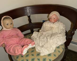 Bye-Lo Baby with label on right and friend (composition?), hanging out in classic Barrel back Arm Chair