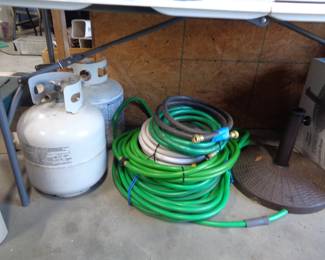 Propane tanks, water hoses, umbrella bases