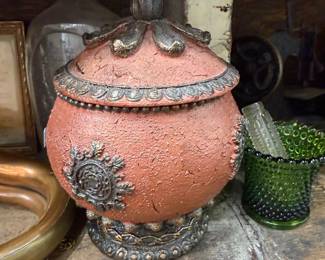 Terracotta lidded jar with ornate metal trim