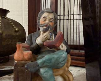 Porcelain figurine of seated pipe smoker