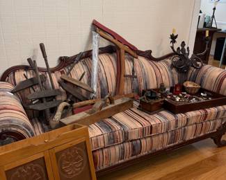 Victorian carved sofa with antique wood clamps and punched tin cabinet