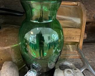 Green glass vase on primitive wood shelf