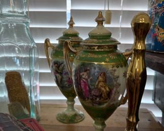 Pair of green and gilt hand-painted portrait urns
