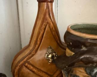 Leather clad decanter with brass crest