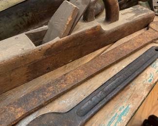 Antique wooden jointer plane and iron wrenches