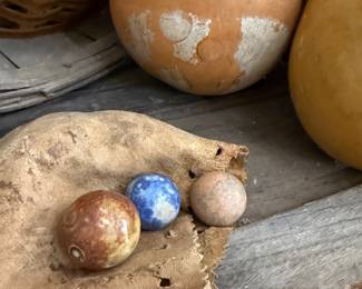 Antique clay marbles on leather pouch
