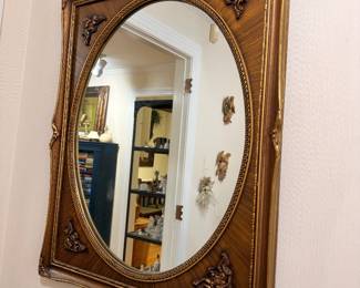 Ornate gilt wood oval wall mirror