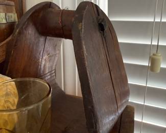 Primitive wooden stool with carved handle