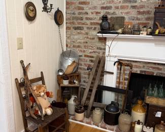 Primitive ladderback chair with stoneware jugs and antique ladder