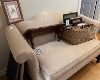Camelback settee with cream upholstery