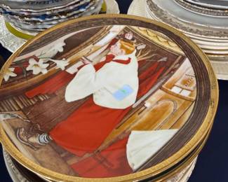 Stacks of collector plates and vintage china