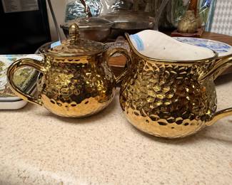 Gold ceramic sugar bowl and creamer set