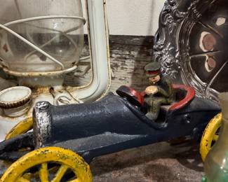 Antique cast iron toy race car with driver