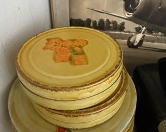 Stack of vintage decorated tin canister lids