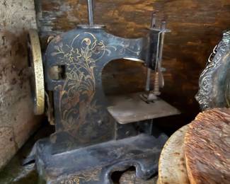Antique gold-stenciled cast iron toy sewing machine