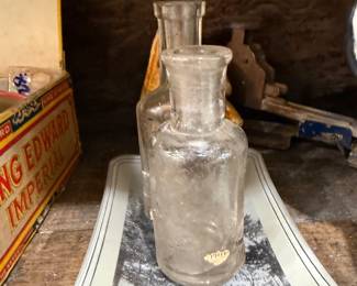 Two antique clear glass apothecary bottles
