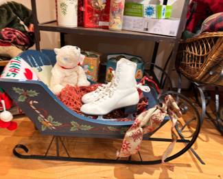 Painted holly sleigh with vintage white ice skates