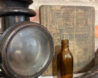 Antique carriage lamp with early geography book