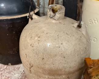 Primitive stoneware jug with wire bail handle