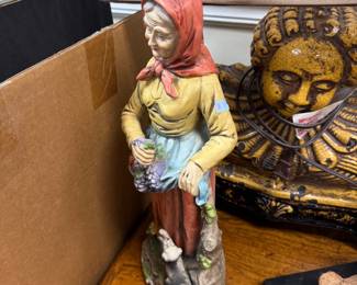 Painted porcelain old woman with grapes figurine