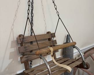 Antique wooden child's porch swing on chains