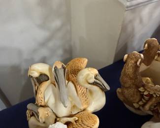 Carved resin pelican group figurine
