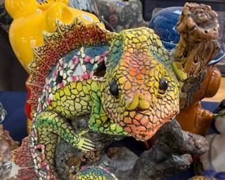 Colorful mosaic chameleon sculpture on branch