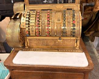 Antique brass cash register on oak marble-top base