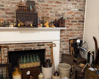 Brick fireplace with stoneware crocks and jugs