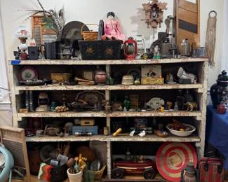 Primitive shelving unit full of antiques and collectibles