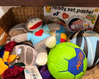 Basket of children's toys with sock monkey plush