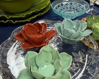 Ceramic lotus flower figurines on cut glass tray