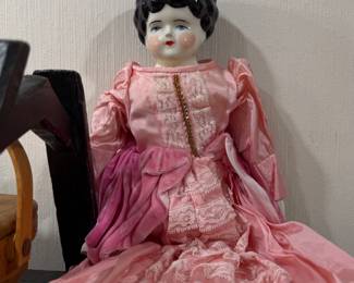 Antique china head doll in pink dress