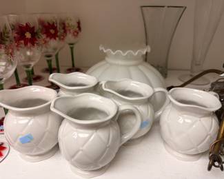 White ceramic pitchers and milk glass lamp shade