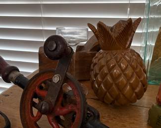 Antique hand crank drill and carved wood pineapple