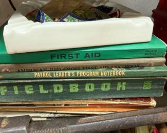 Boy Scout Fieldbook and First Aid books with patch-filled ashtray