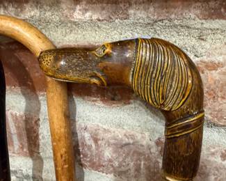 Carved dog head walking cane with brass collar