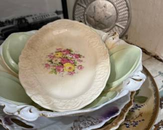 Stack of antique floral china plates