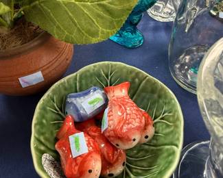 Ceramic goldfish figurines in green cabbage leaf bowl