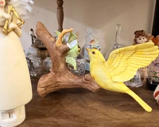 Yellow bird figurine on ceramic branch