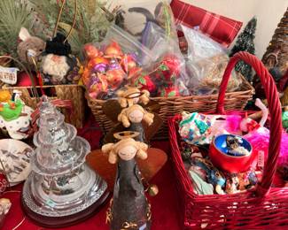 Baskets of Christmas ornaments with lighted glass tree