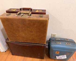 Vintage leather briefcases and blue hard-shell suitcase