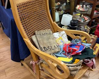 Antique cane back rocking chair with textiles