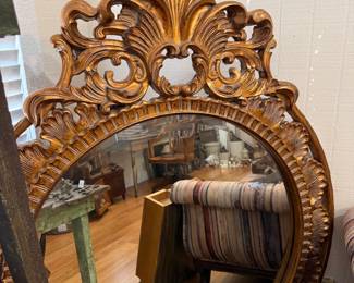 Ornate giltwood carved round beveled wall mirror