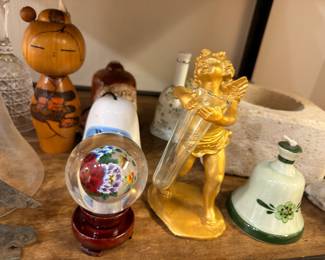 Kokeshi doll, glass paperweight and gold cherub