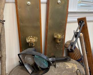 Pair of brass wall sconces on wood backplates