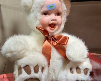 Porcelain baby doll in white bear costume